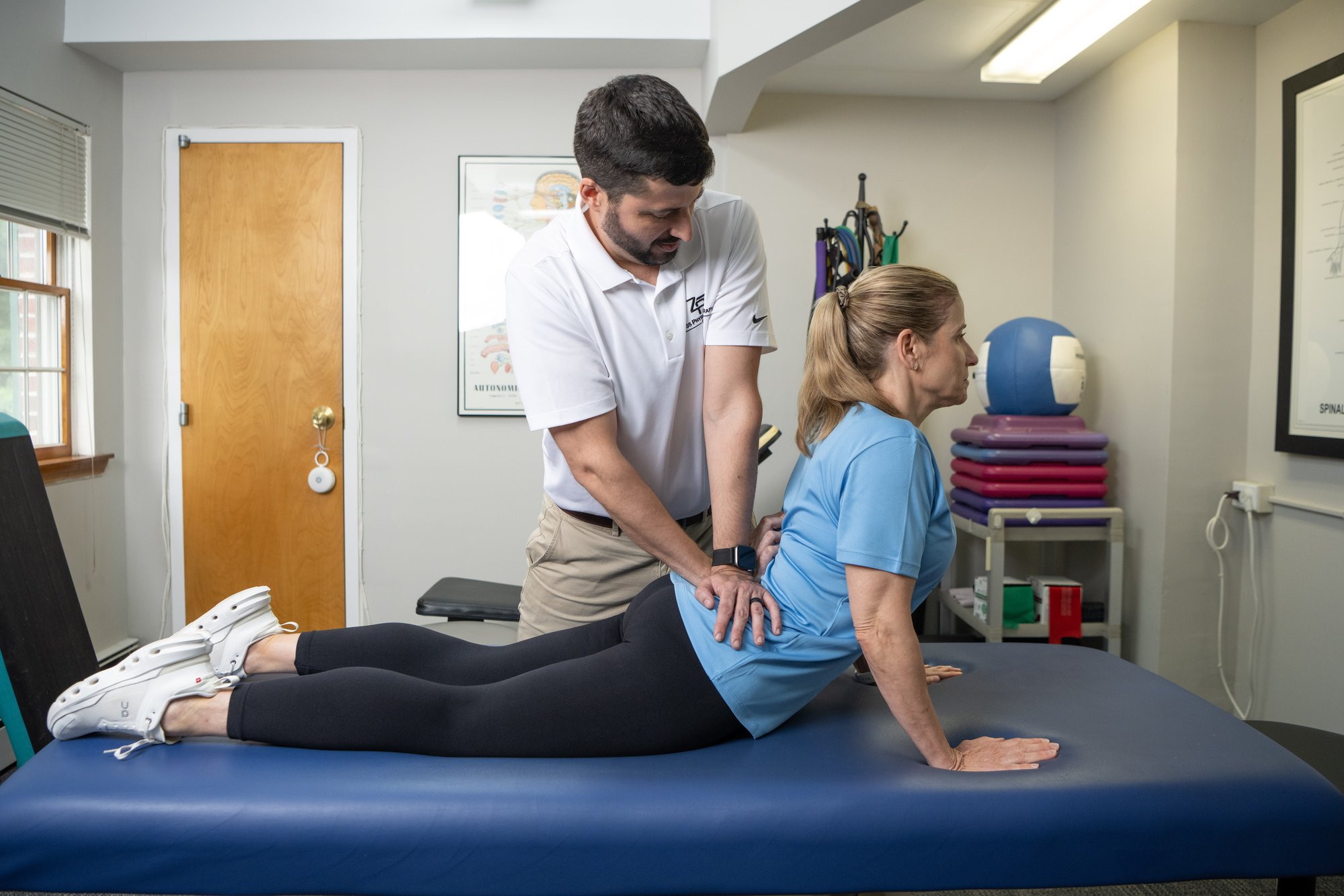 Russell Zeiss, DPT, guiding a patient through a McKenzie Method prone extension exercise