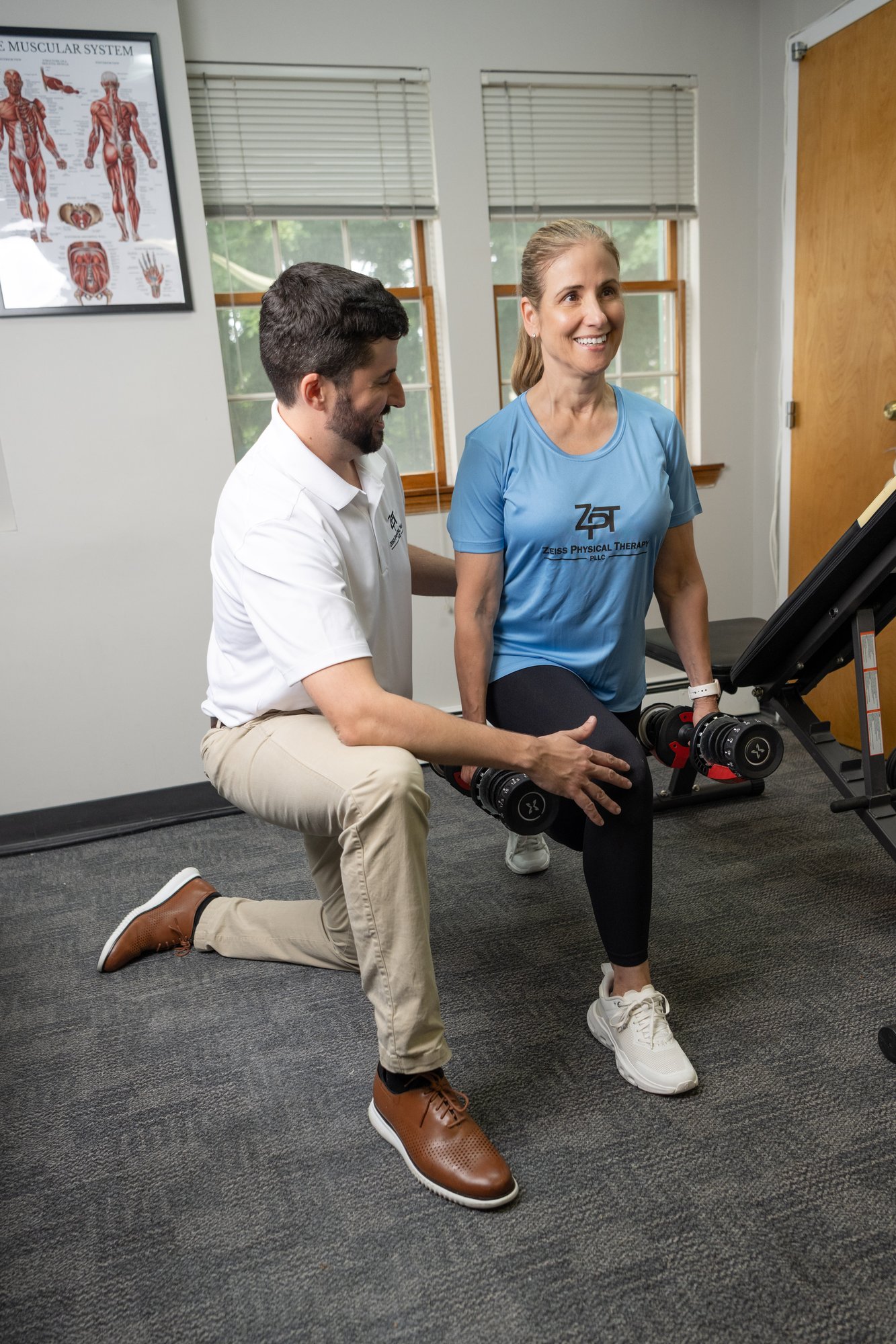 Russell Zeiss, DPT, coaching a patient through a dumbbell split squat during PT-guided strength training